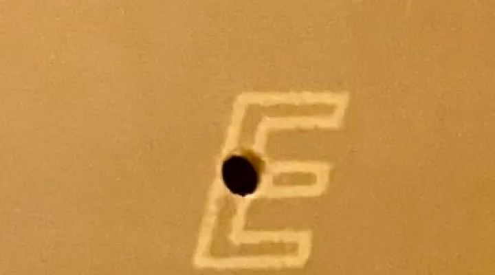 Close-up of the E logo printed on the gamepad's PCB.