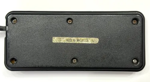 Back of the gamepad showing a very worn Made in Malaysia gold sticker.