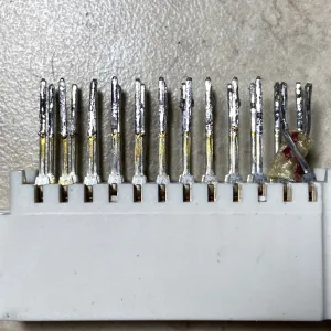 A photo of the deconstructed port taken from the side, more clearly showing the swapped pins and a tiny bit of insulation between them.