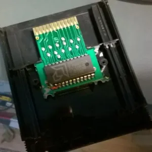 Photo (slightly blurry) showing the inside of the Frostbite 2600 cartridge; one can discern that something has been modified where the ROM chip pins meet the PCB.