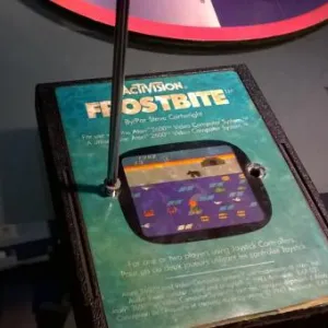 Photo depicting a screw being removed from the front of a Frostbite cartridge for the Atari 2600