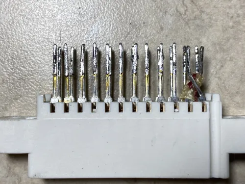 A photo of the deconstructed port taken from the side, more clearly showing the swapped pins and a tiny bit of insulation between them.